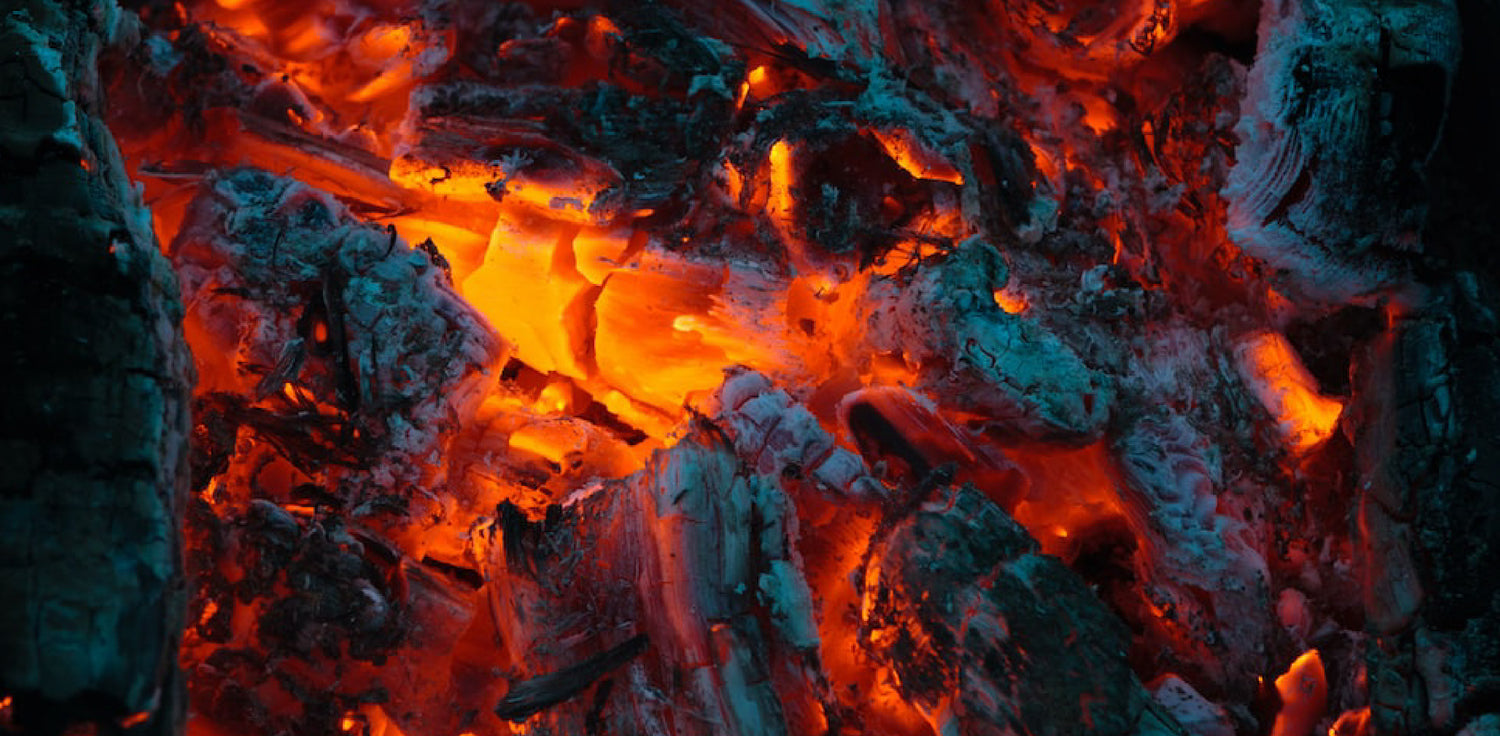 Charcoal - A photo of charcoal, a black, porous, and lightweight material obtained by burning wood or other organic matter in the absence of air. The photo shows a pile of charcoal pieces with irregular shapes and a dark, matte surface. Charcoal is commonly used as a fuel source, as well as in various industrial, culinary, and artistic applications. 
