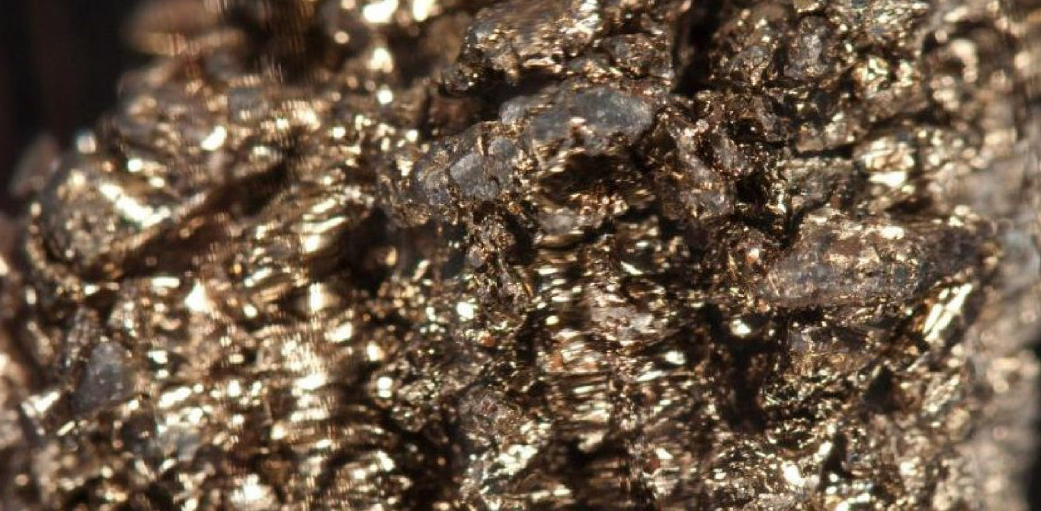 Barium - A photo of a sample of barium, a chemical element with the symbol Ba and atomic number 56. The photo shows a small amount of metallic barium, which is a soft, silvery-white alkaline earth metal. Barium is a reactive element that quickly tarnishes when exposed to air, forming a dull oxide coating.